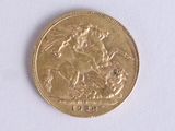 a gold coin with a picture of a man riding a horse on it