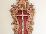 a cross hanging on the wall in the corner of a room