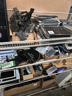 a lot of electronic equipment on the shelves in the room