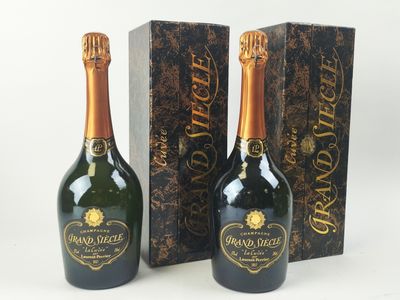 deux bouteilles de champagne posées l'une à côté de l'autre sur une table