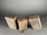 three metal containers are sitting on a table with a rope