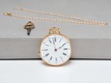 an image of a gold pocket watch sitting on top of a box