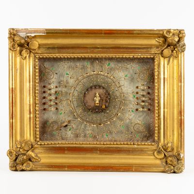 a gold frame with a clock in it on a white surface