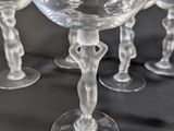 several empty wine glasses are lined up on a black table