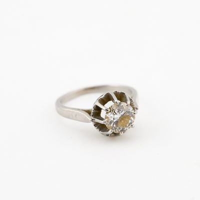 a close up of a diamond ring on a white surface