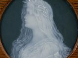 a picture of a woman with long hair in a wooden frame