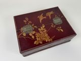 a red box with gold flowers and birds on it