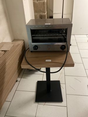 a toaster oven sitting on a table in a kitchen