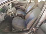 the interior of a car with blue seats and a steering wheel