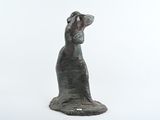 statue of a dog on a white surface with a white background
