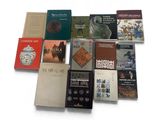 several books on a white surface with a white background
