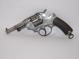 an old gun with a wooden handle on a white surface
