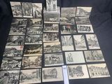 several old black and white photos of people and buildings on a table