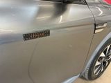a close up of a car door with a sticker on it