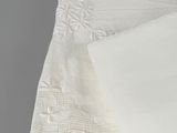 a close up of a white table cloth with a white napkin