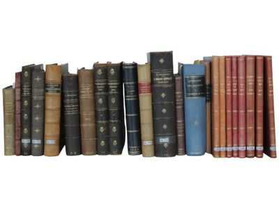 many books that are lined up together on a shelf