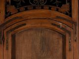 a cat that is sitting in front of a wooden door