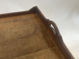 a wooden tray that has a handle on it