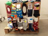 many pairs of socks on a pallet in a room