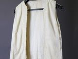 an image of a white vest hanging on a hanger