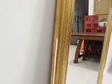 a mirror on the wall next to a table