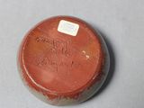 a small brown object with writing on it on a table