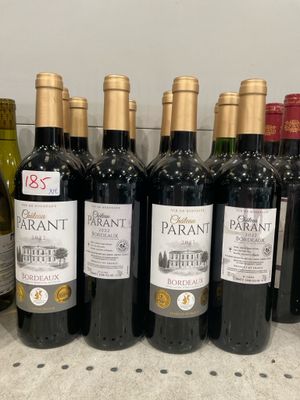 several bottles of wine are lined up on a counter