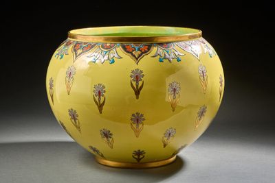 un vase jaune orné d'un motif floral