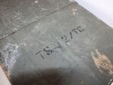 a metal box with writing on it sitting on the floor