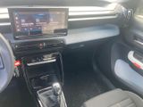 the interior of a car with a touch screen and a steering wheel