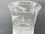 a clear glass cup sitting on top of a table