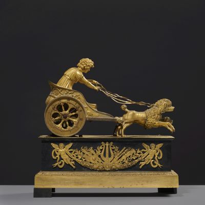 une image représentant une statue d'une femme tirant une charrette avec un chien