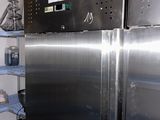 a refrigerator that is in a kitchen with a lot of items on the shelves