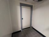 a door in the corner of a room with a tile floor
