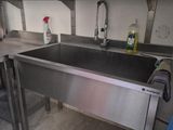 a stainless steel sink in the middle of a kitchen