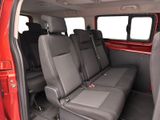 a red van with four seats in the back of it