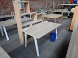 many tables and chairs in a room with a brick wall