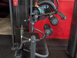 a gym equipment set up in front of a red wall