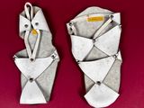 pair of origami sandals on a red background