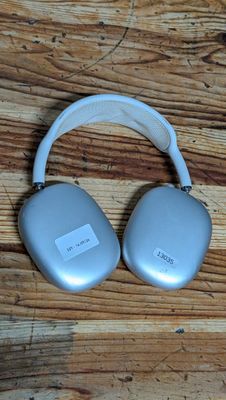 an image of a pair of headphones sitting on top of a wooden table