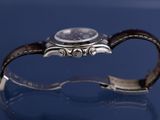 an image of a close up of a wrist watch on a table