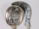 a silver spoon and a silver spoon with a picture on it