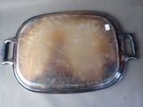 a silver plate with a handle on it on a table