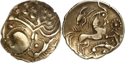 a close up of two silver coins with designs on them