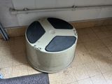 a trash can sitting on the floor next to a door