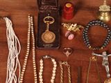 a lot of jewelry on a table with a crucifix
