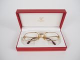 a pair of glasses in a red box on a white surface