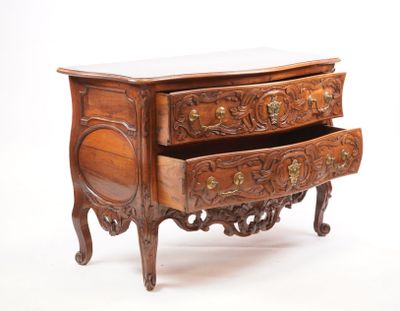 a small wooden chest of drawers with a marble top