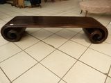 a wooden bench sitting on a tiled floor in a living room