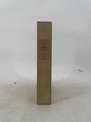 an old book sitting on top of a snow covered ground
